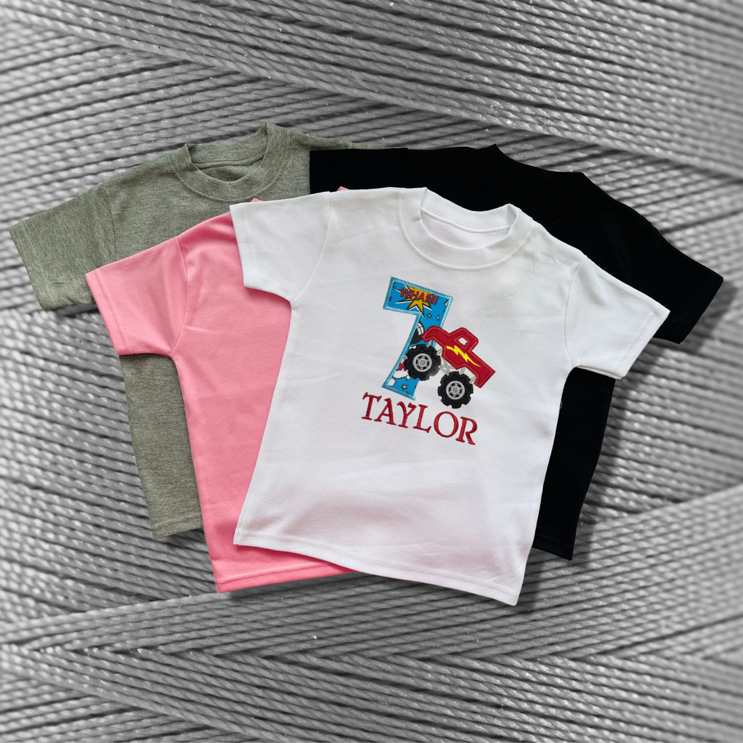 Childrens soft cotton t-shirt. Embroidered applique on the front with the birthday age, monster truck design and the childs name.