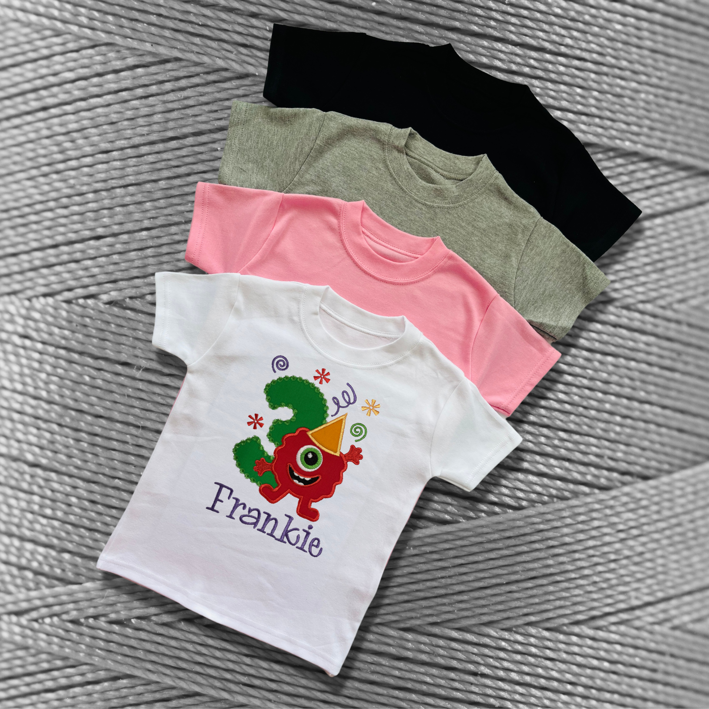 Childrens soft cotton t-shirt. Embroidered applique on the front with the birthday age, funny monster design and the childs name.