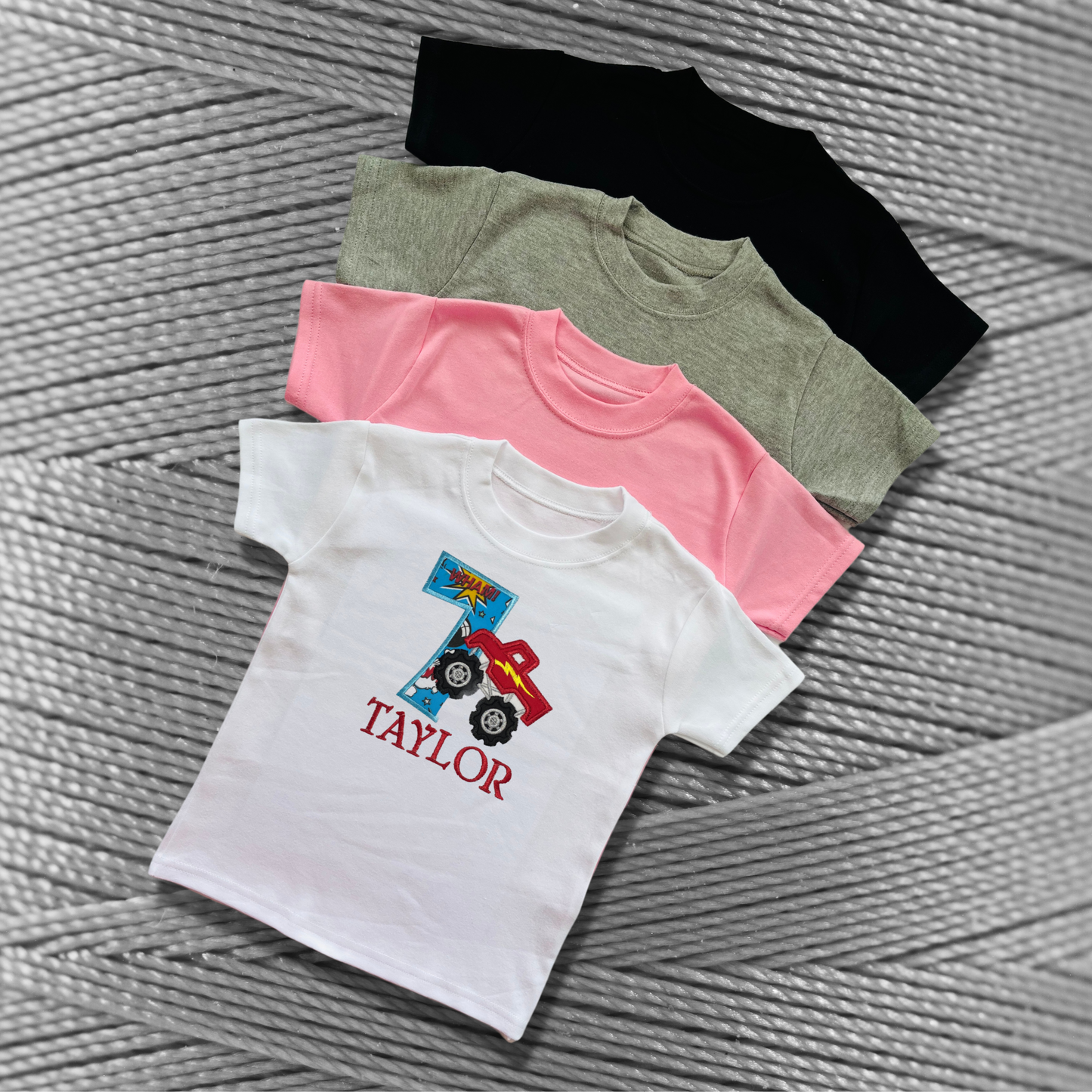 Childrens soft cotton t-shirt. Embroidered applique on the front with the birthday age, monster truck design and the childs name.
