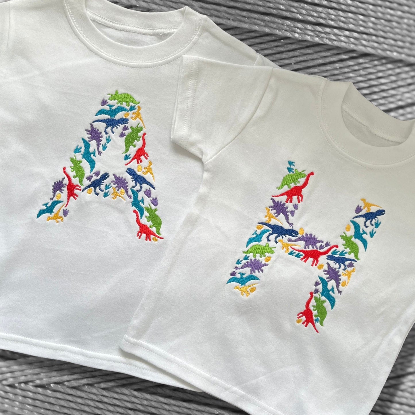 Personalised Embroidered Children's Dinosaur Top. Colourful Dinosaur's Make Up the Letter of the Alphabet. A Perfect Gift for Dinosaur Fans.