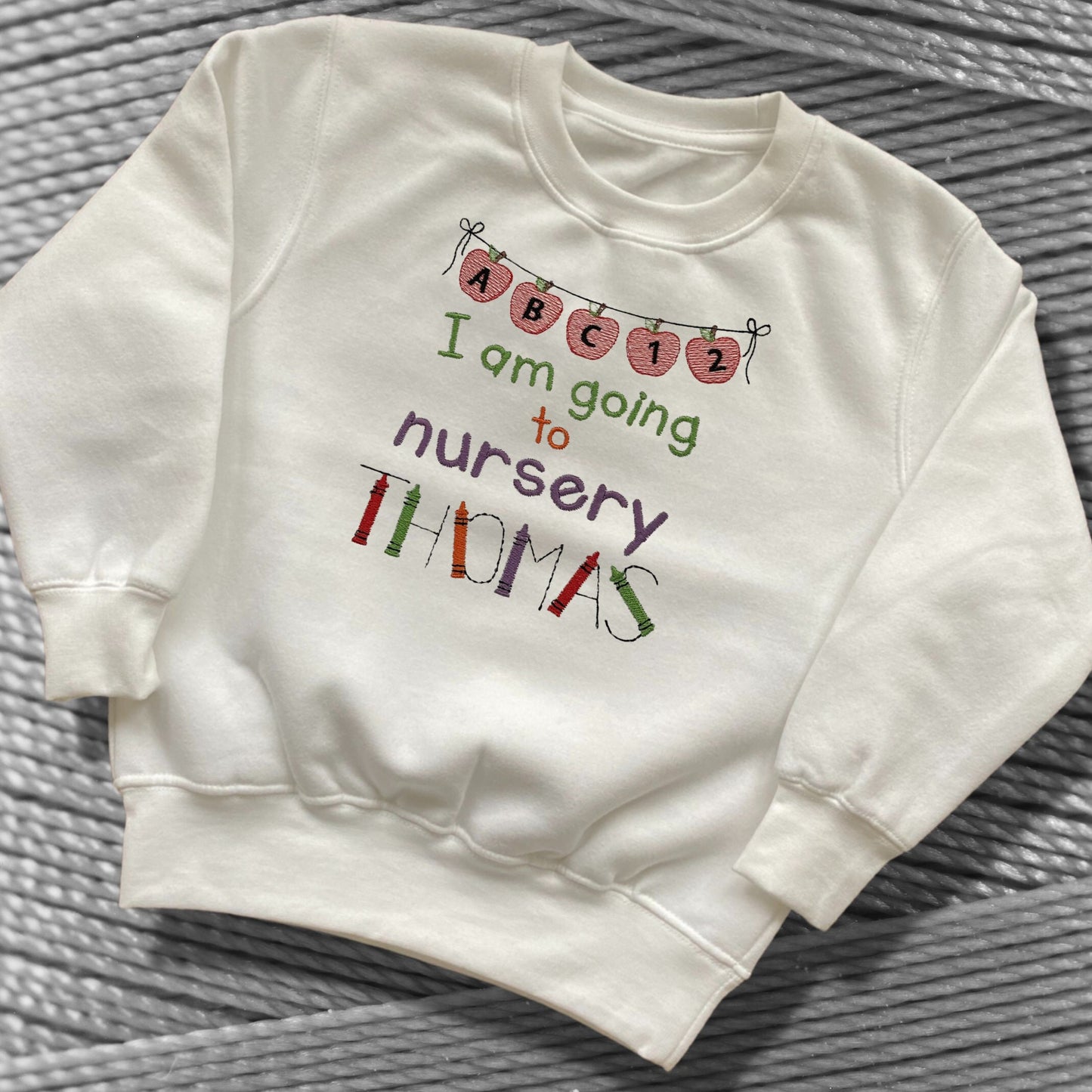 Personalised Embroidered 'I am going to nursery' Tops. Personalised with Child's Name in a Cute Colourful Crayon Font. Choice of Garment