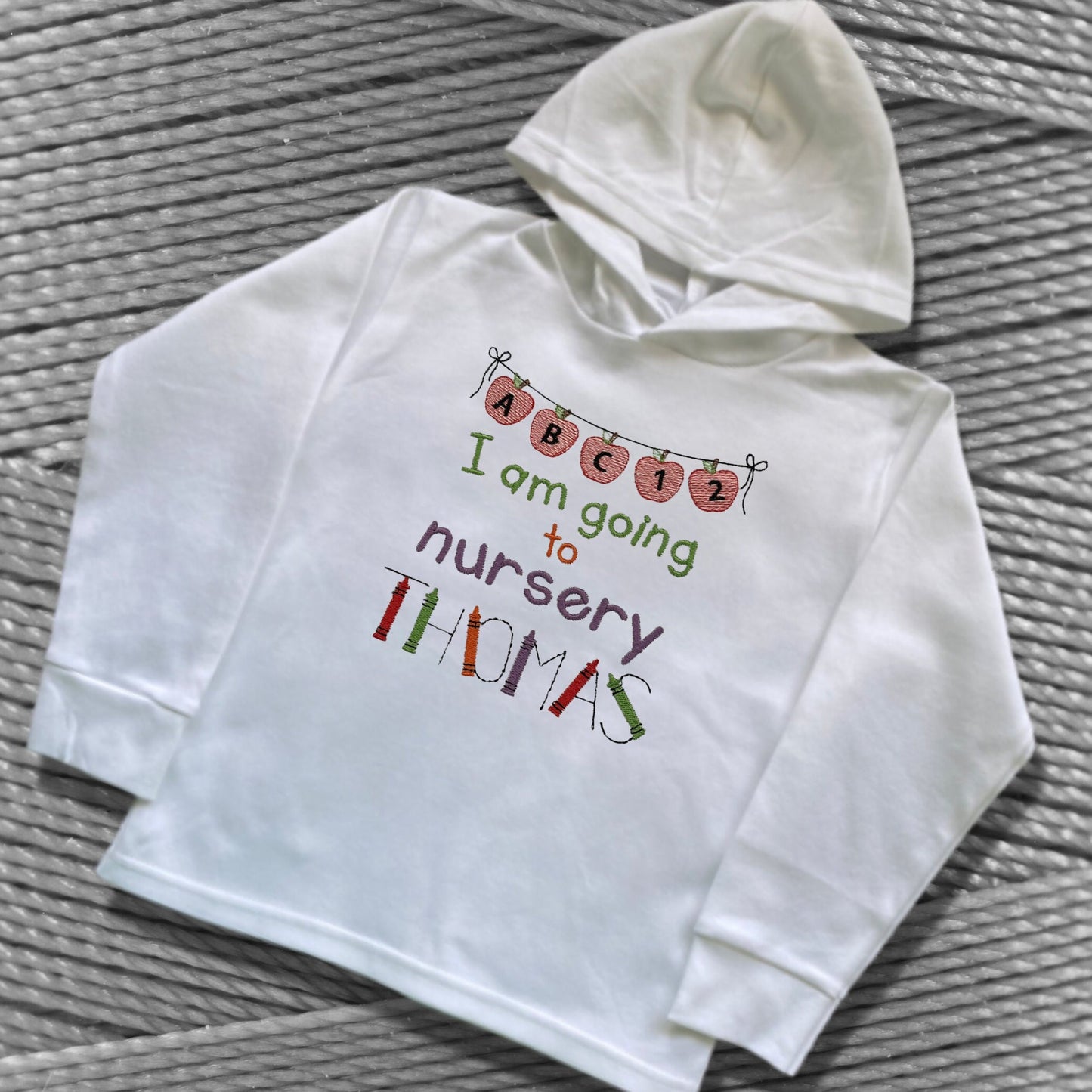 Personalised Embroidered 'I am going to nursery' Tops. Personalised with Child's Name in a Cute Colourful Crayon Font. Choice of Garment