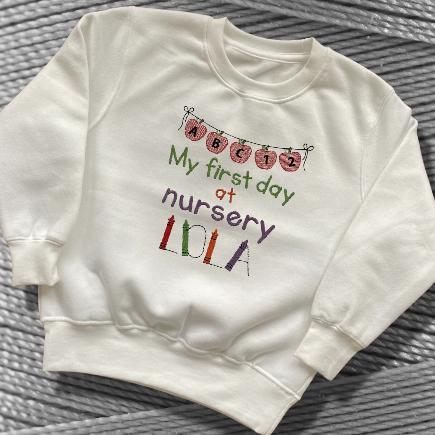 Personalised Embroidered 'My first day at nursery' Tops. Personalised with Child's Name in a Cute Colourful Crayon Font. Choice of Garment