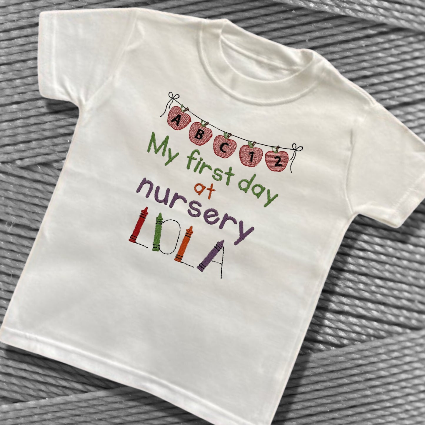 Personalised Embroidered 'My first day at nursery' Tops. Personalised with Child's Name in a Cute Colourful Crayon Font. Choice of Garment