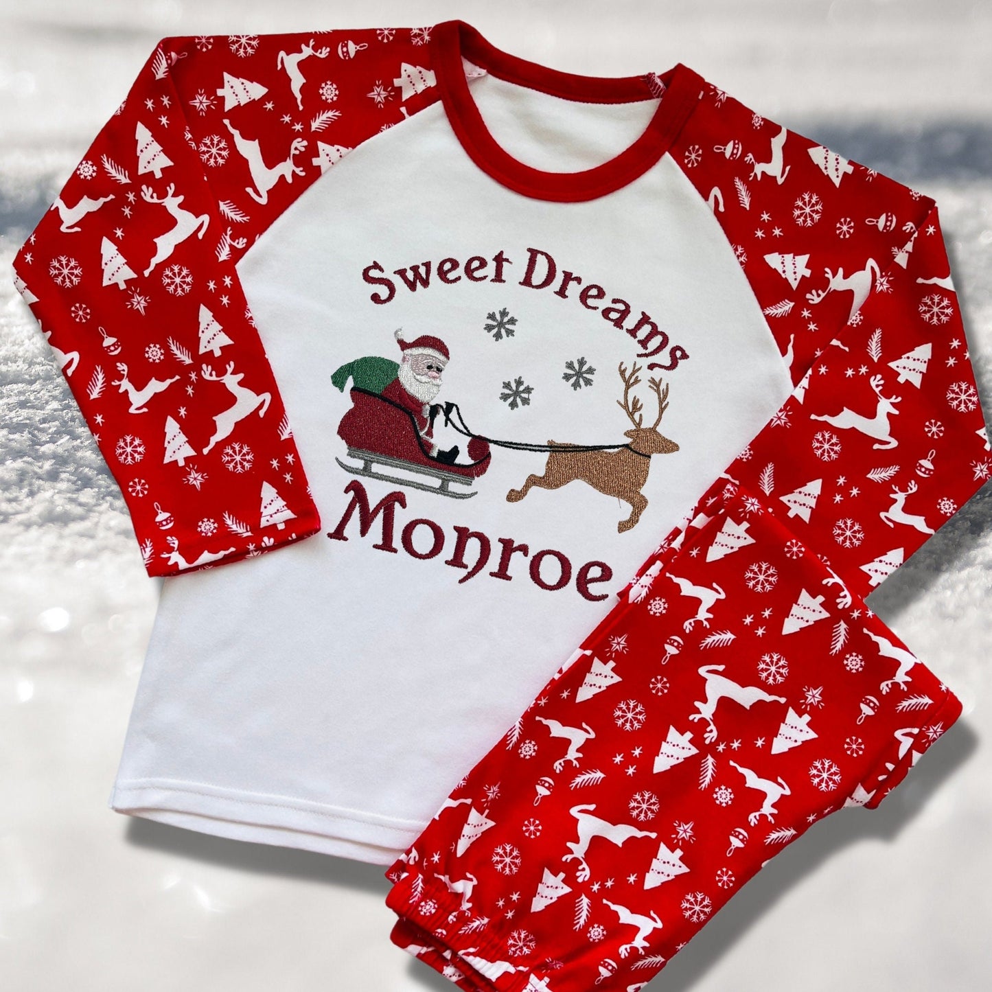 Personalised Embroidered Christmas Childrens Pyjamas and Rompersuits with Santa, his Sleigh and a Reindeer. With the Words 'Sweet Dreams'.
