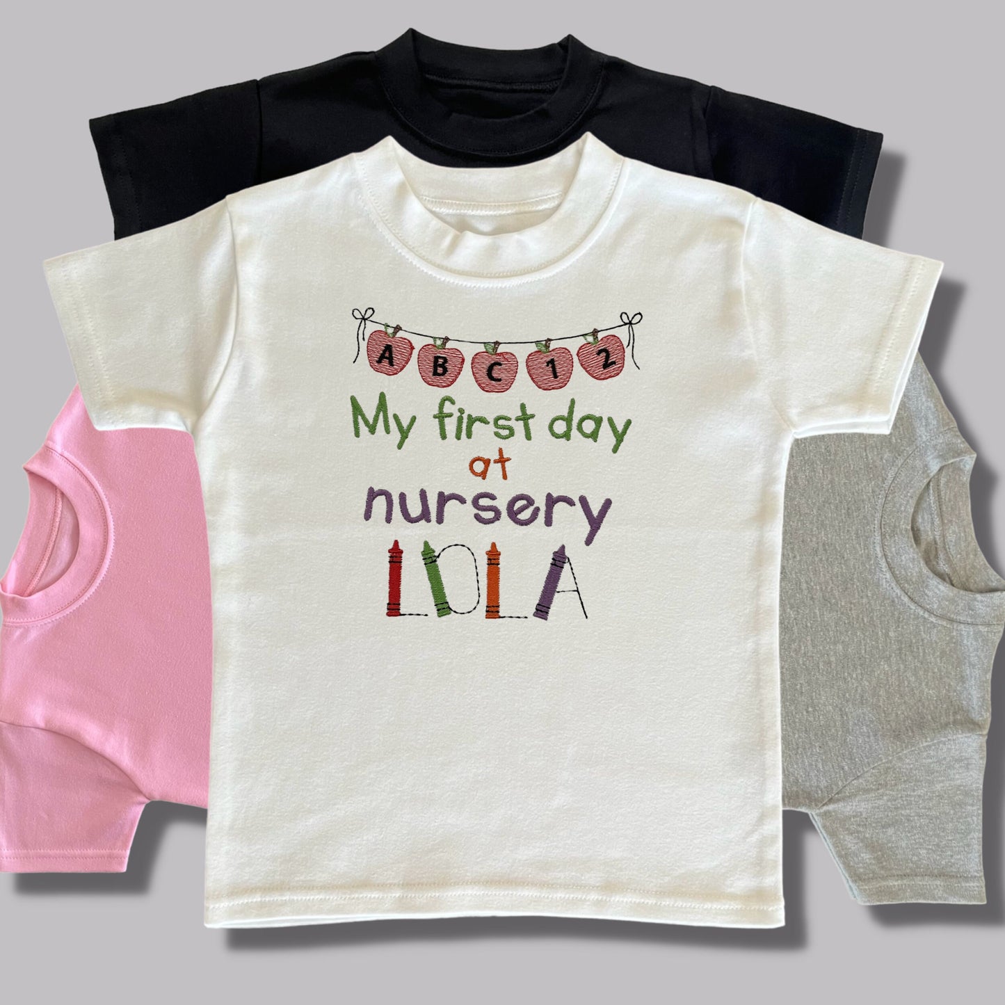 Personalised Embroidered 'My first day at nursery' Tops. Personalised with Child's Name in a Cute Colourful Crayon Font. Choice of Garment