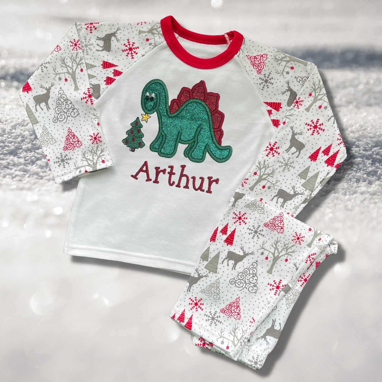 Personalised Embroidered Christmas Childrens Pyjamas and Rompersuits. Cute Dinosaur Putting a Star on his Tree. Finished with Child's Name