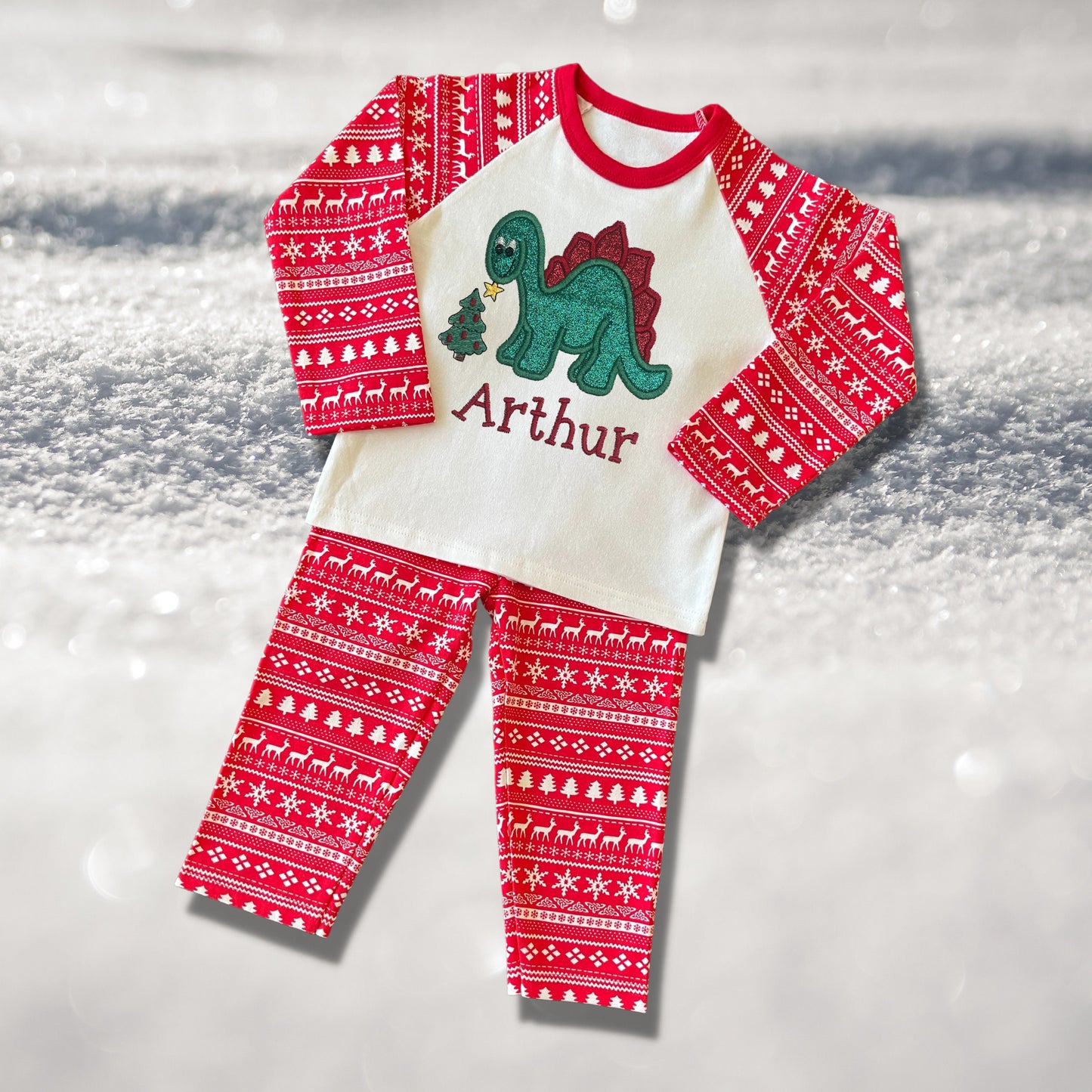 Personalised Embroidered Christmas Childrens Pyjamas and Rompersuits. Cute Dinosaur Putting a Star on his Tree. Finished with Child's Name