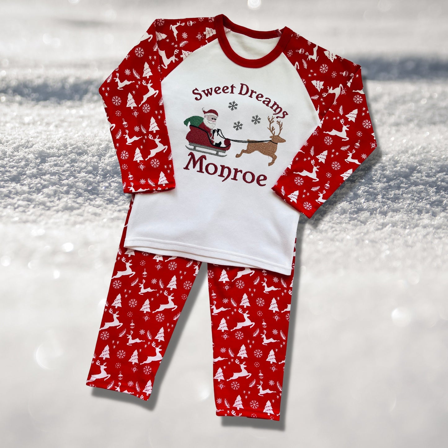 Personalised Embroidered Christmas Childrens Pyjamas and Rompersuits with Santa, his Sleigh and a Reindeer. With the Words 'Sweet Dreams'.