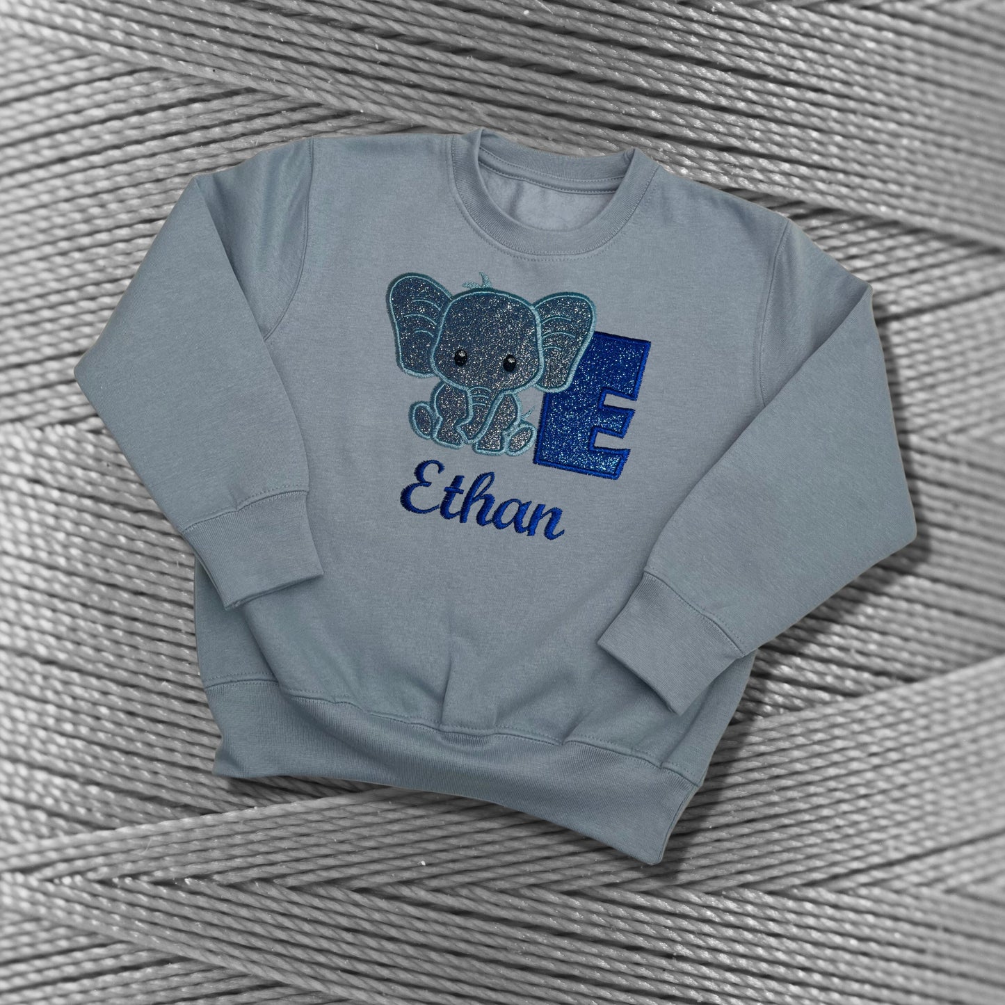 Children's Personalised Embroidered Top With a Cute Elephant Design. A Beautiful Design Using Glittery Blues with Child's Name and Initial
