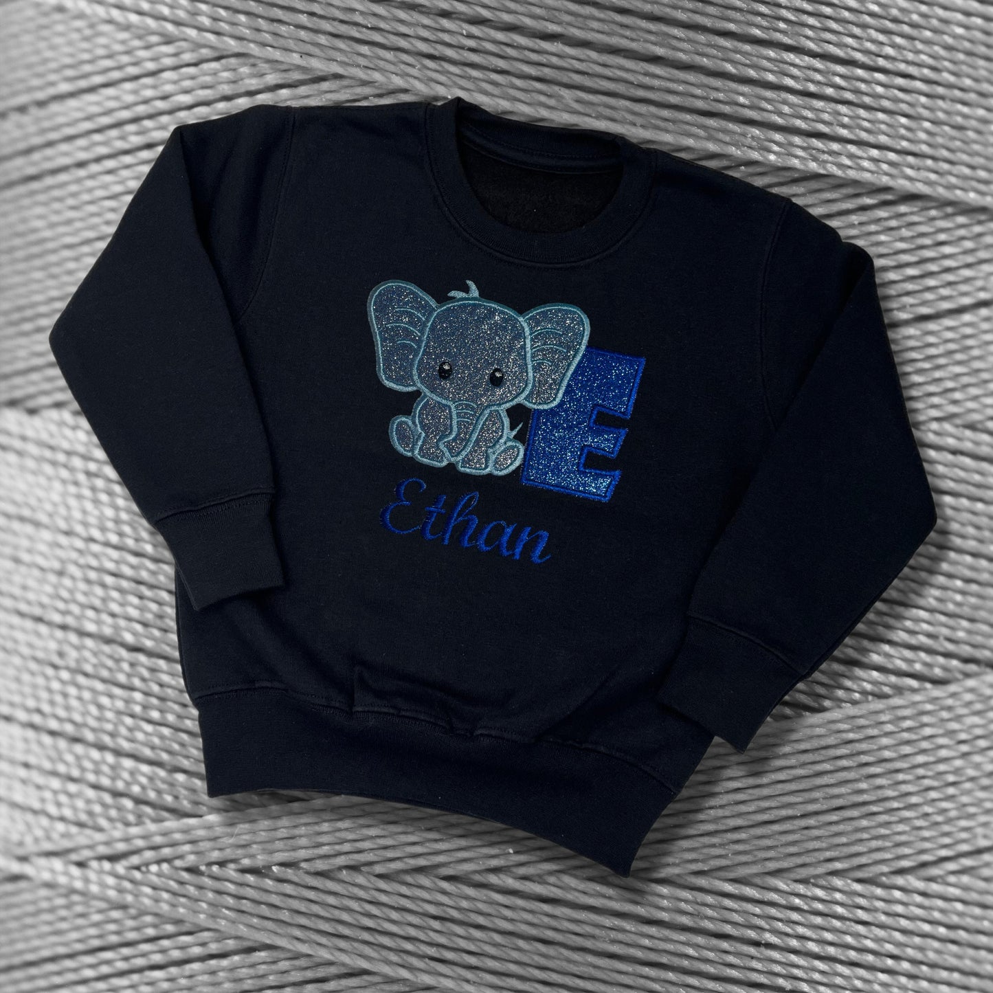 Children's Personalised Embroidered Top With a Cute Elephant Design. A Beautiful Design Using Glittery Blues with Child's Name and Initial