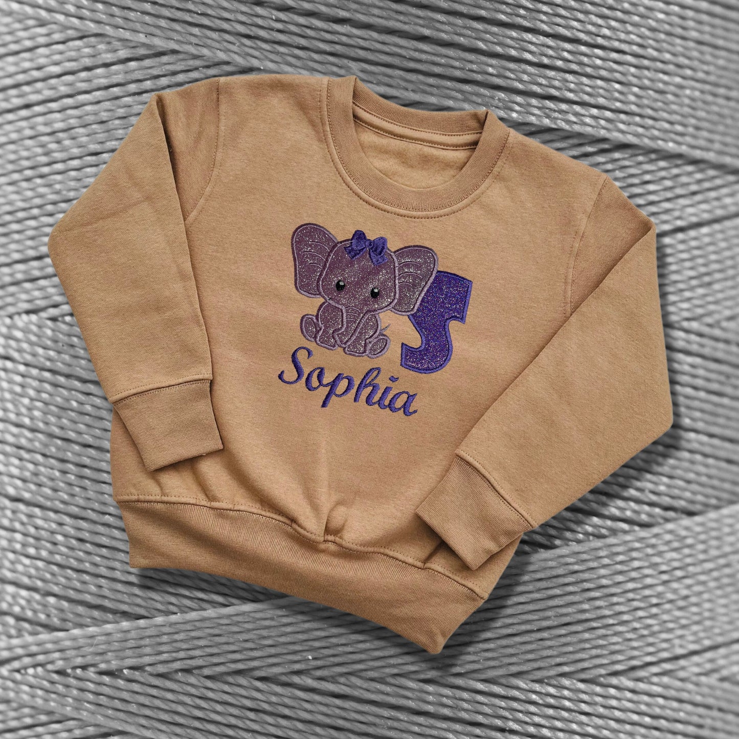 Children's Personalised Embroidered Top With a Cute Elephant Design. A Beautiful Design Using Glittery Purples with Child's Name and Initial