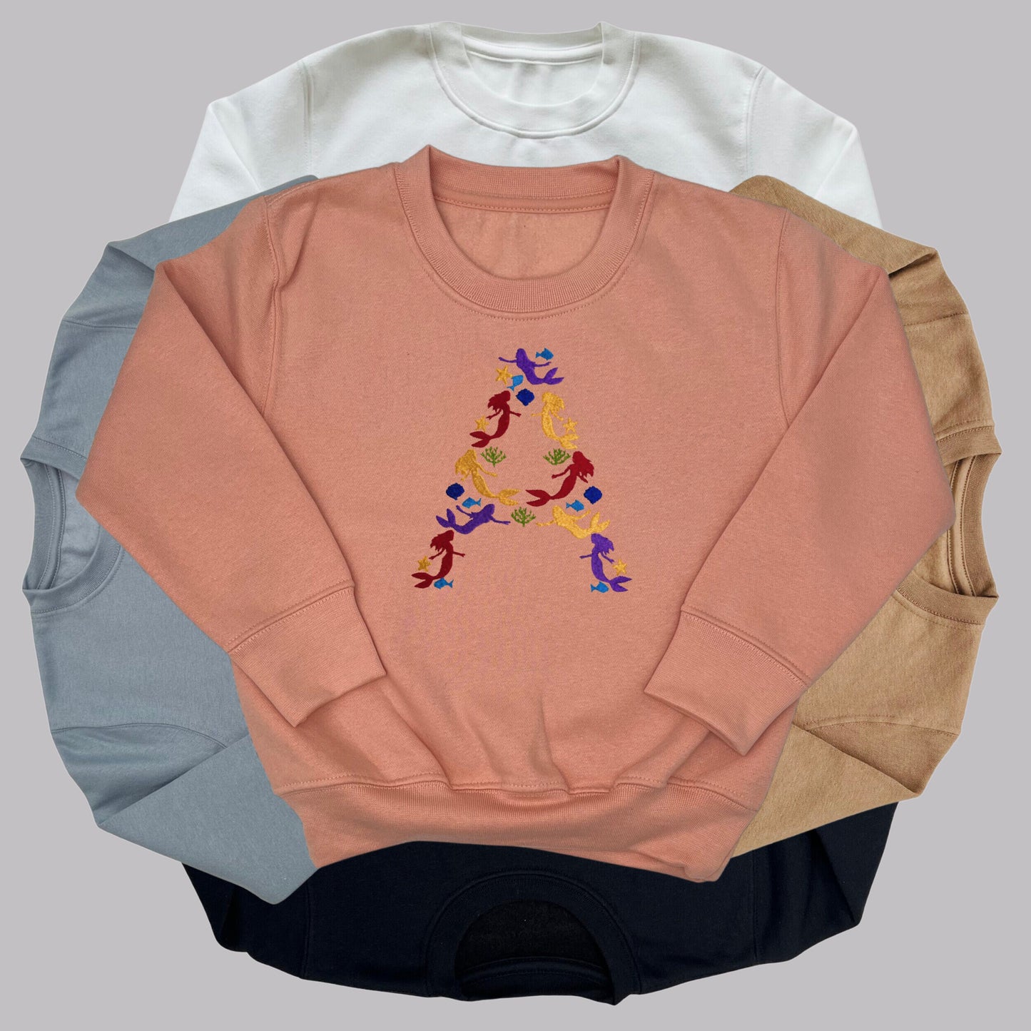 Children's Personalised Embroidered Top. Colourful Mermaids make up the Child's Initial. Perfect Gift for Children who Love Mermaids.