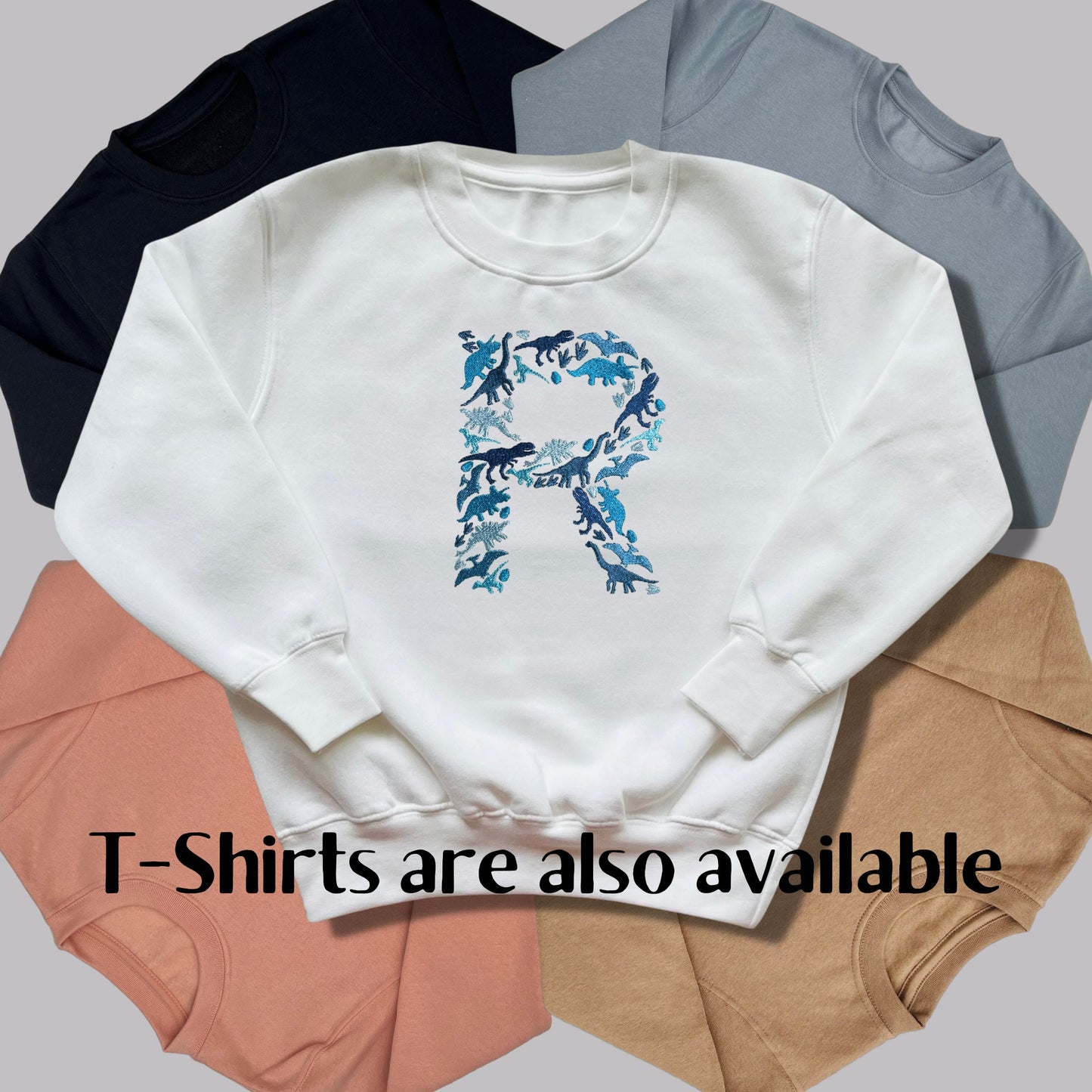 Personalised Embroidered Childrens Dinosaur Top. Dinosaurs in Beautiful Shades of Blue Make Up the Letter. A Perfect Gift for Dinosaur Fans.