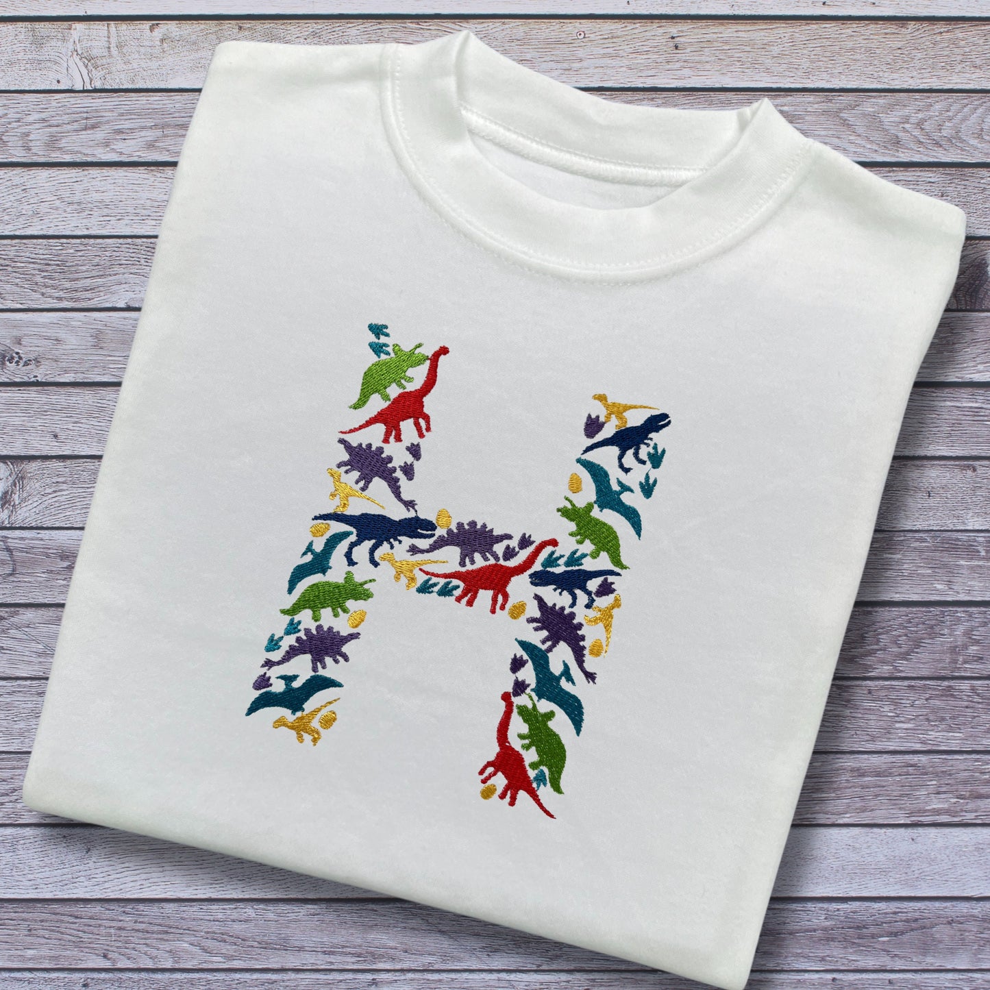 Personalised Embroidered Children's Dinosaur Top. Colourful Dinosaur's Make Up the Letter of the Alphabet. A Perfect Gift for Dinosaur Fans.
