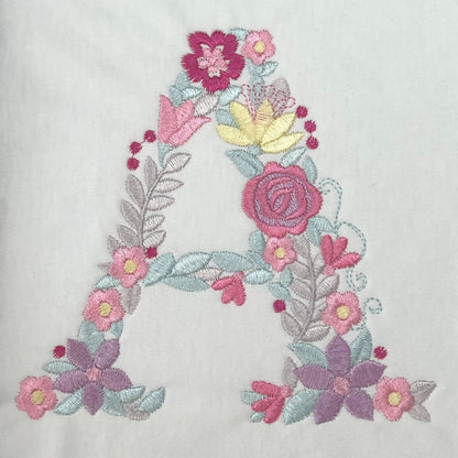 Personalised Embroidered Children's Monogram Top. Cute Floral Letter Embroidered in Pastel Pinks and Lilac.