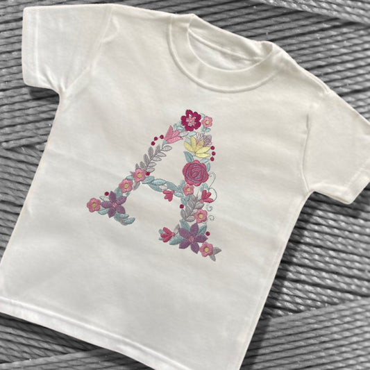 Personalised Embroidered Children's Monogram Top. Cute Floral Letter Embroidered in Pastel Pinks and Lilac.
