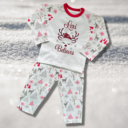 Personalised Embroidered Christmas Childrens Pyjamas and Rompersuits with a Gorgeous Winter Reindeer and the Words 'Believes' under the Name