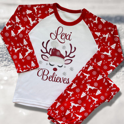 Personalised Embroidered Christmas Childrens Pyjamas and Rompersuits with a Gorgeous Winter Reindeer and the Words 'Believes' under the Name