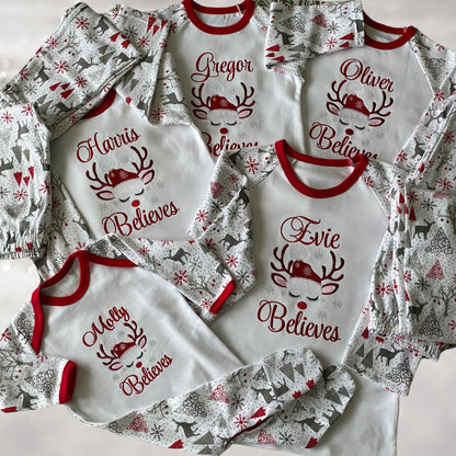 Personalised Embroidered Christmas Childrens Pyjamas and Rompersuits with a Gorgeous Winter Reindeer and the Words 'Believes' under the Name