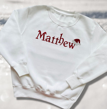 Personalised Embroidered Childrens Christmas Top. Cute Design with Name and Santa Hat. Perfect for the Christmas Season. Choice of Garment