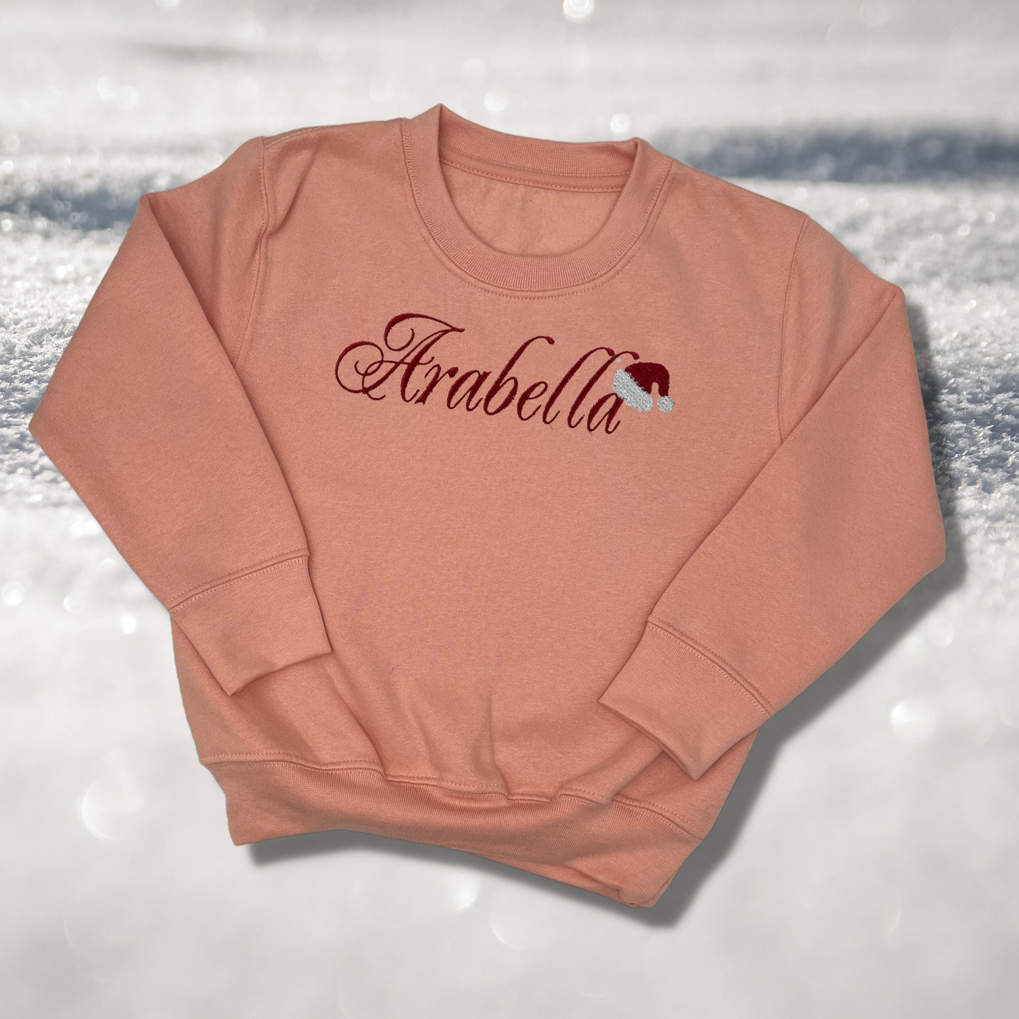 Personalised Embroidered Childrens Christmas Top. Cute Design with Name and Santa Hat. Perfect for the Christmas Season. Choice of Garment