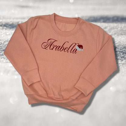 Personalised Embroidered Childrens Christmas Top. Cute Design with Name and Santa Hat. Perfect for the Christmas Season. Choice of Garment