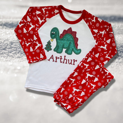 Personalised Embroidered Christmas Childrens Pyjamas and Rompersuits. Cute Dinosaur Putting a Star on his Tree. Finished with Child's Name