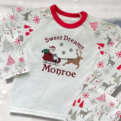 Personalised Embroidered Christmas Childrens Pyjamas and Rompersuits with Santa, his Sleigh and a Reindeer. With the Words 'Sweet Dreams'.