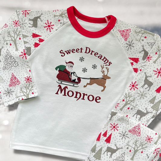 Personalised Embroidered Christmas Childrens Pyjamas and Rompersuits with Santa, his Sleigh and a Reindeer. With the Words 'Sweet Dreams'.