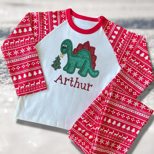 Personalised Embroidered Christmas Childrens Pyjamas and Rompersuits. Cute Dinosaur Putting a Star on his Tree. Finished with Child's Name