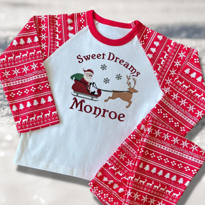 Personalised Embroidered Christmas Childrens Pyjamas and Rompersuits with Santa, his Sleigh and a Reindeer. With the Words 'Sweet Dreams'.