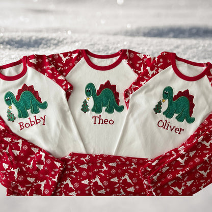 Personalised Embroidered Christmas Childrens Pyjamas and Rompersuits. Cute Dinosaur Putting a Star on his Tree. Finished with Child's Name