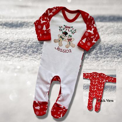 Personalised Embroidered Christmas Childrens Pyjamas and Rompersuits with the Cutest Gingerbread Girl and Boy Holding Hands Under a Garland.