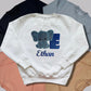 Children's Personalised Embroidered Top With a Cute Elephant Design. A Beautiful Design Using Glittery Blues with Child's Name and Initial