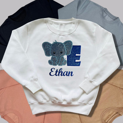 Children's Personalised Embroidered Top With a Cute Elephant Design. A Beautiful Design Using Glittery Blues with Child's Name and Initial