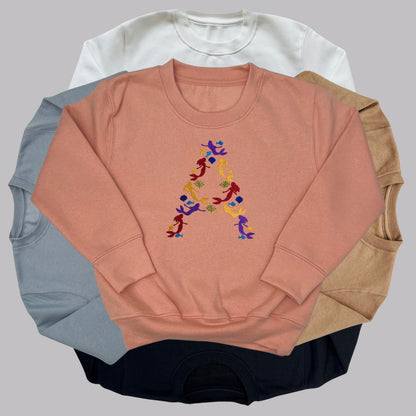 Children's Personalised Embroidered Top. Colourful Mermaids make up the Child's Initial. Perfect Gift for Children who Love Mermaids.