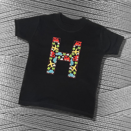 Personalised Embroidered Children's Top. Colourful Cars Trains and Planes Make Up the Letter. A Perfect Gift for Kids who Love Vehicles.
