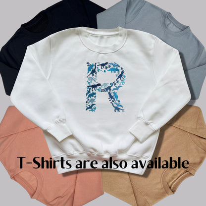 Personalised Embroidered Childrens Dinosaur Top. Dinosaurs in Beautiful Shades of Blue Make Up the Letter. A Perfect Gift for Dinosaur Fans.