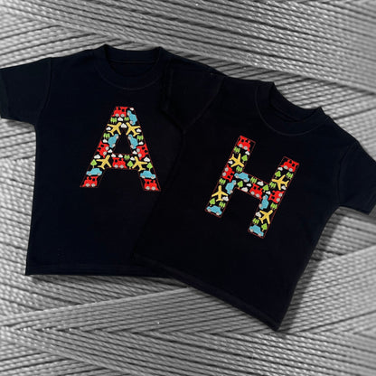 Personalised Embroidered Children's Top. Colourful Cars Trains and Planes Make Up the Letter. A Perfect Gift for Kids who Love Vehicles.