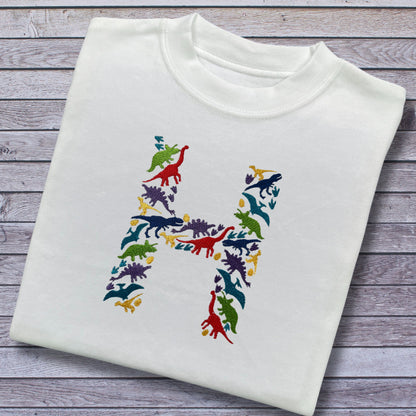 Personalised Embroidered Children's Dinosaur Top. Colourful Dinosaur's Make Up the Letter of the Alphabet. A Perfect Gift for Dinosaur Fans.